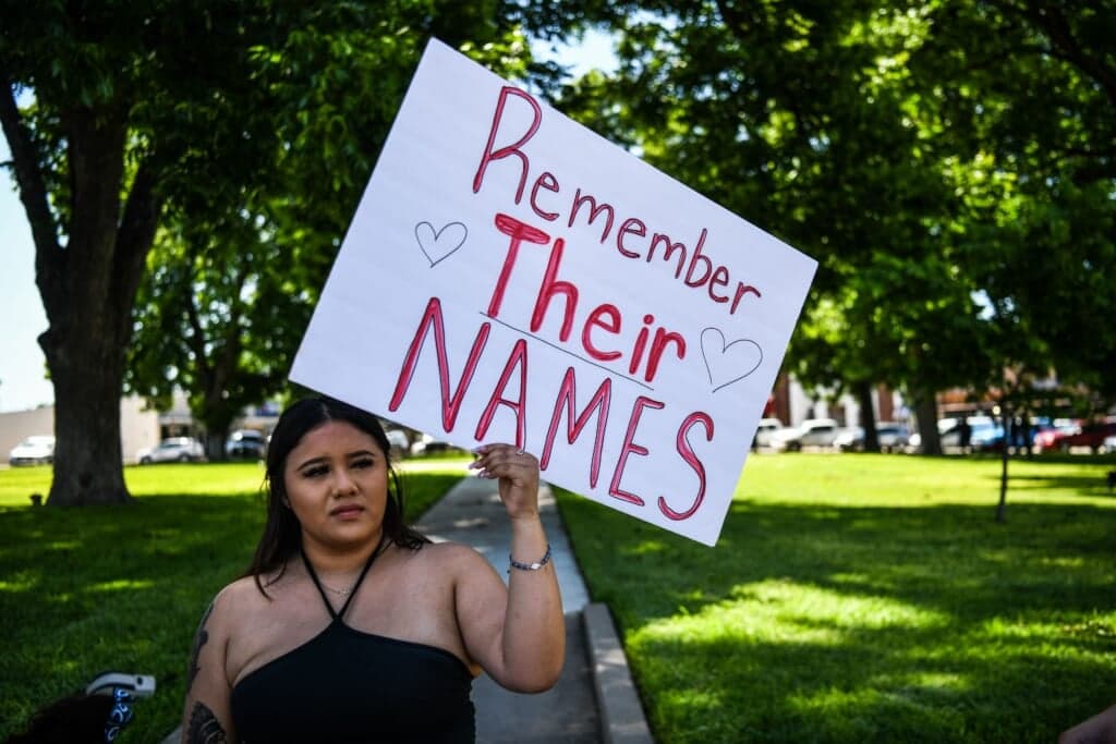 A local resident holds a placard