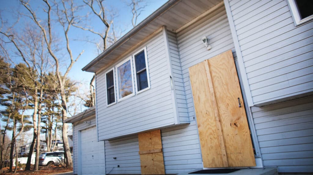 A foreclosed home stands boarded up