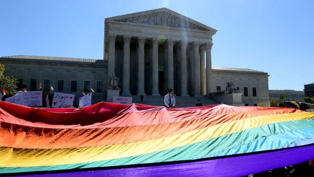 Protesters hold pro-gay rights flags outside the U.S. Supreme Court
