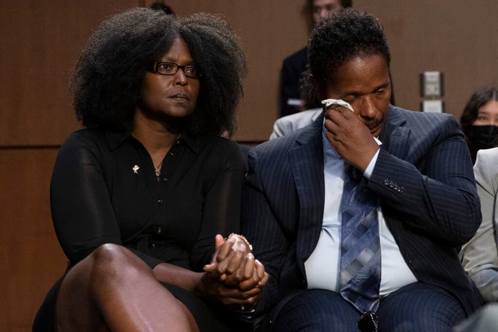 Raymond Whitfield reacts as his brother talks about their mother, Ruth Whitfield
