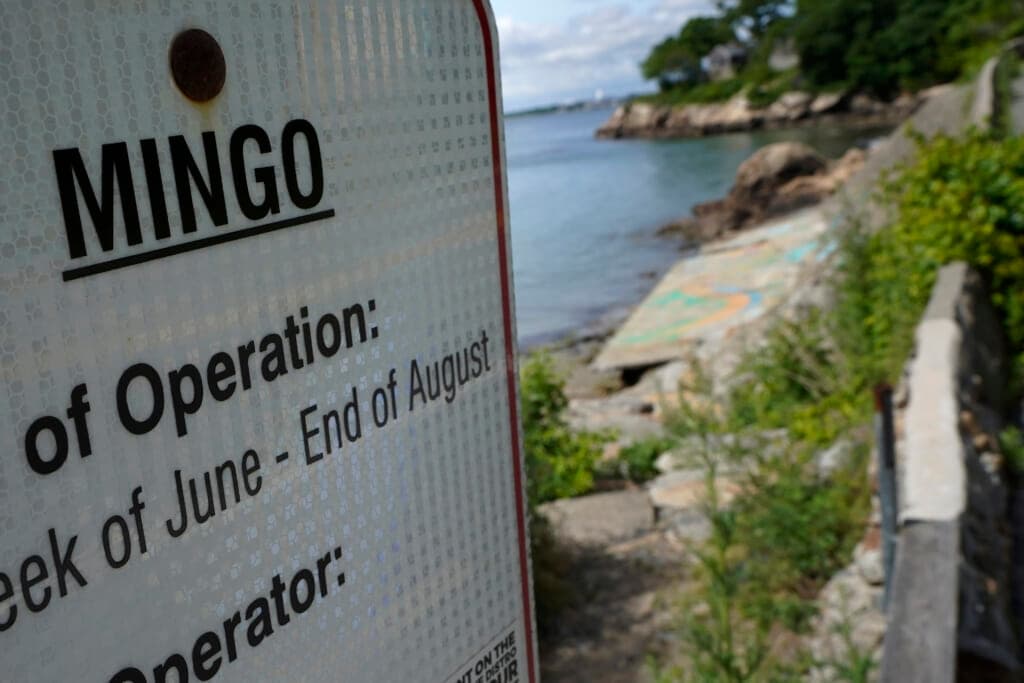 An advisory lists the name Mingo on a sign at an entrance to Mingo Beach