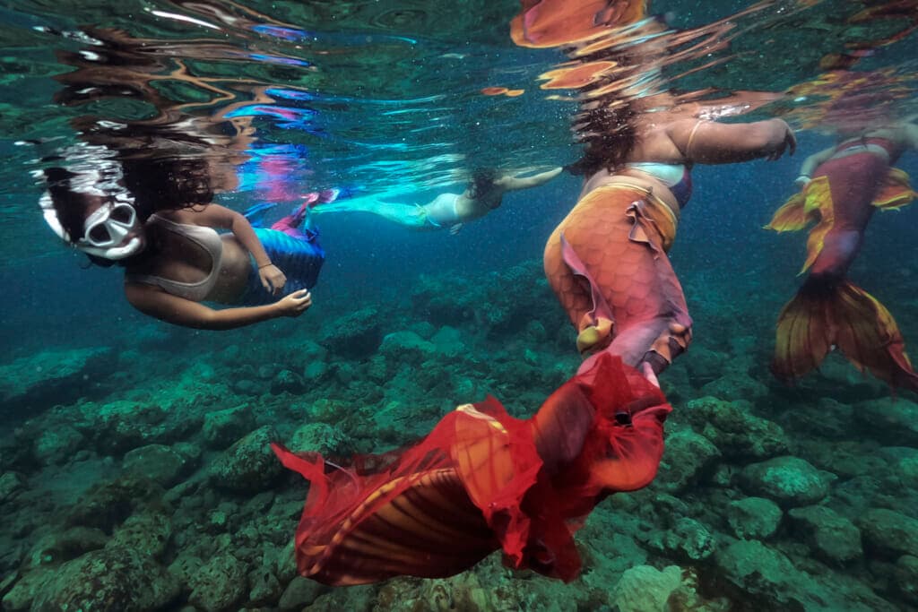 Shelah Candado, Jennica Secuya, Meryll Louise Reque and Queen Pangke Tabora swim during a mermaiding class