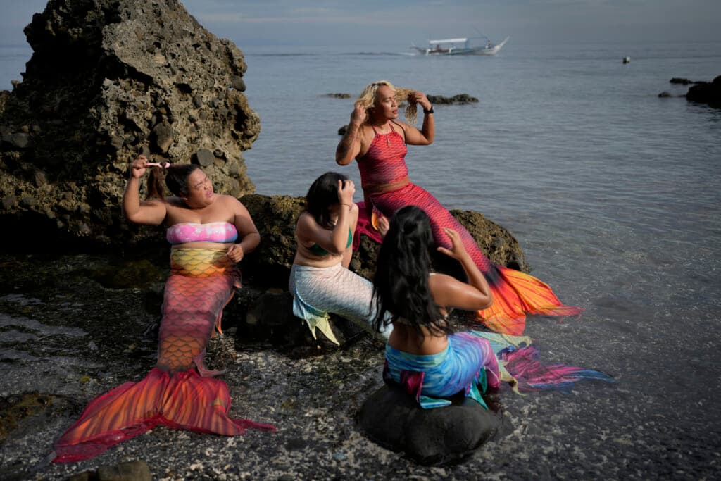 Queen Pangke Tabora, right, and her students prepare for a mermaiding class