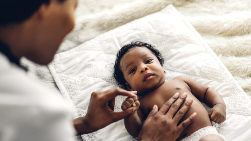A woman touching a baby