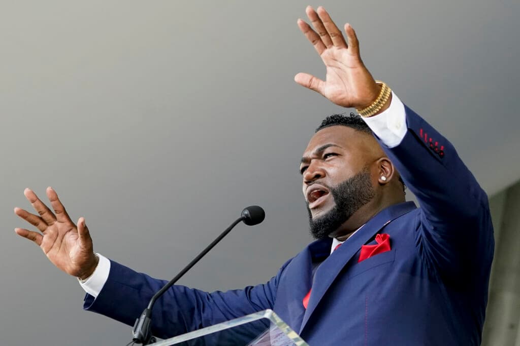 Hall of Famer David Ortiz, formerly of the Boston Red Sox, holds out his hands at the microphone
