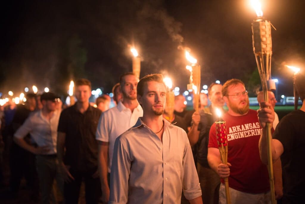Neo-Nazis and white supremacists with tiki torches take part in a march