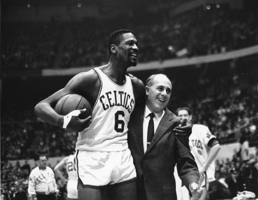 Bill Russell, star of the Boston Celtics, is congratulated by coach Arnold “Red” Auerbach