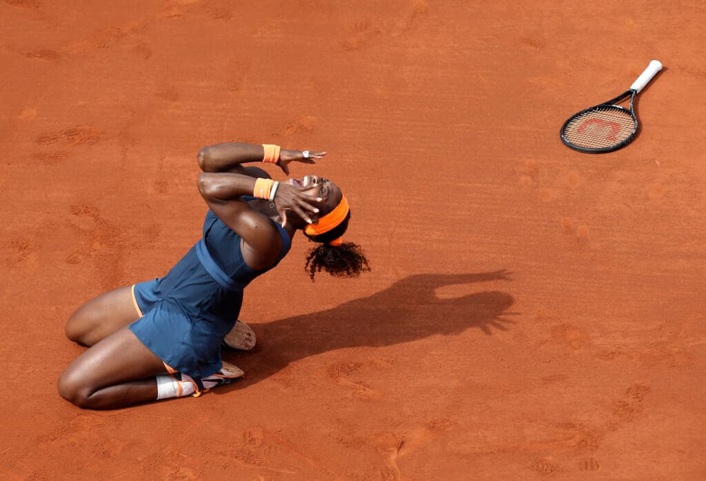Tennis player Serena Williams kneeling on the court
