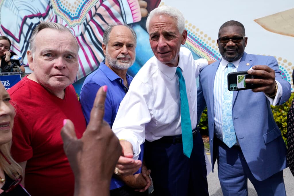 Rep. Charlie Crist, D-Fla., second from right, talks with a supporter