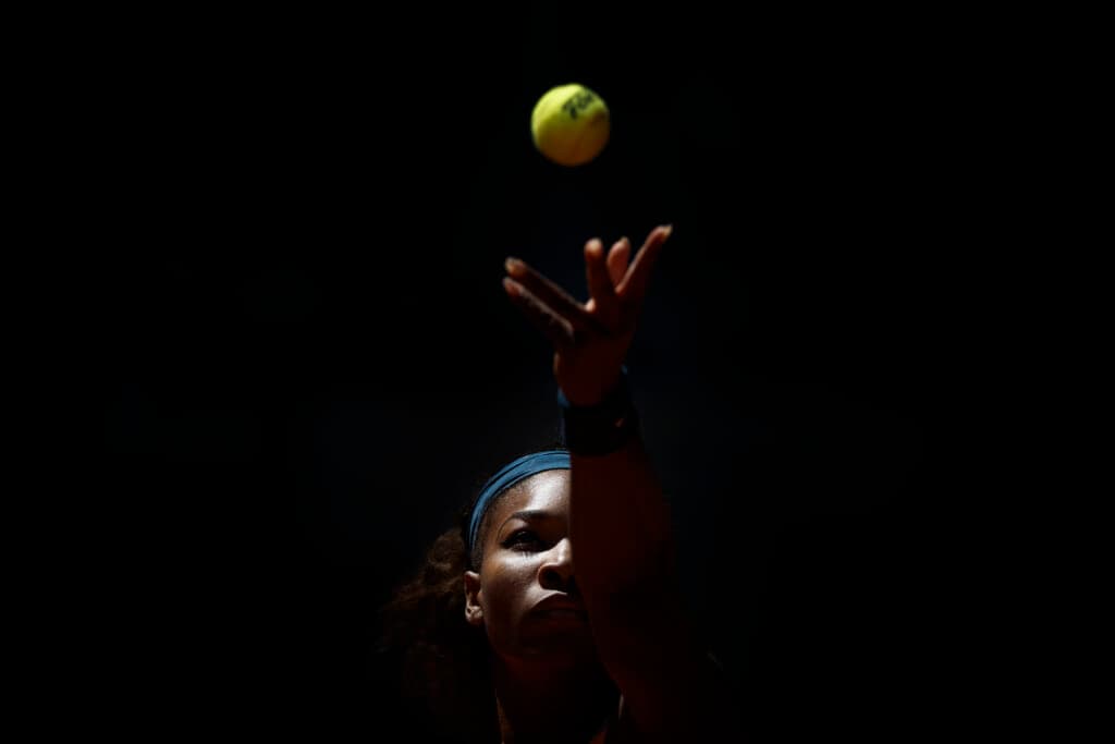 Tennis player Serena Williams throws a tennis ball up