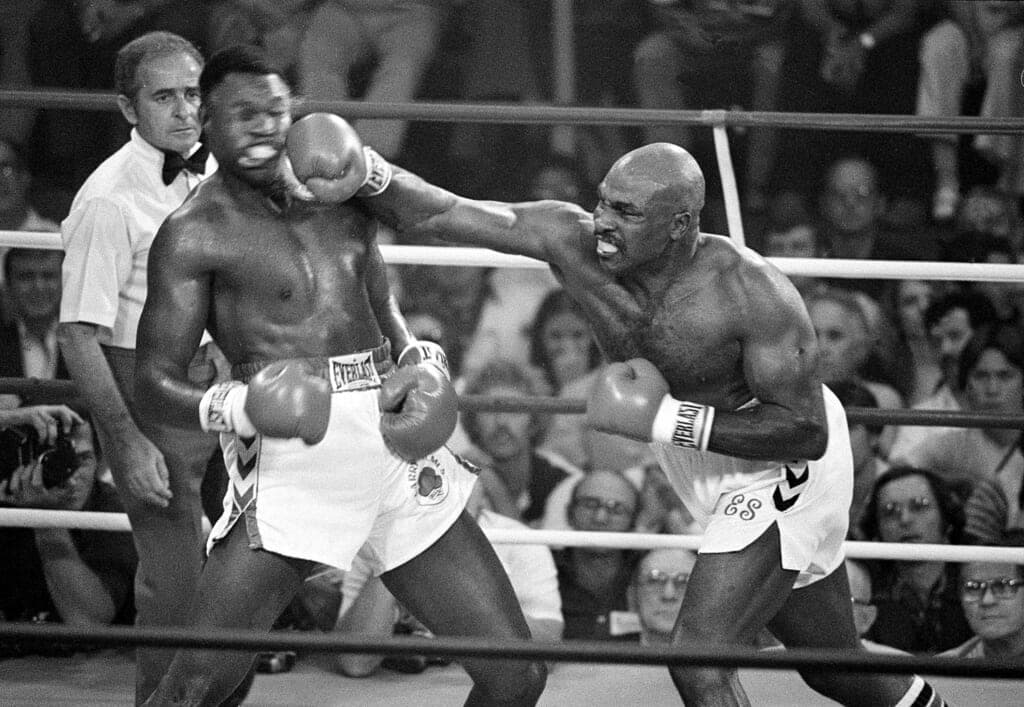 Heavyweight champion Larry Holmes being punched by boxer Earnie Shavers in 1979