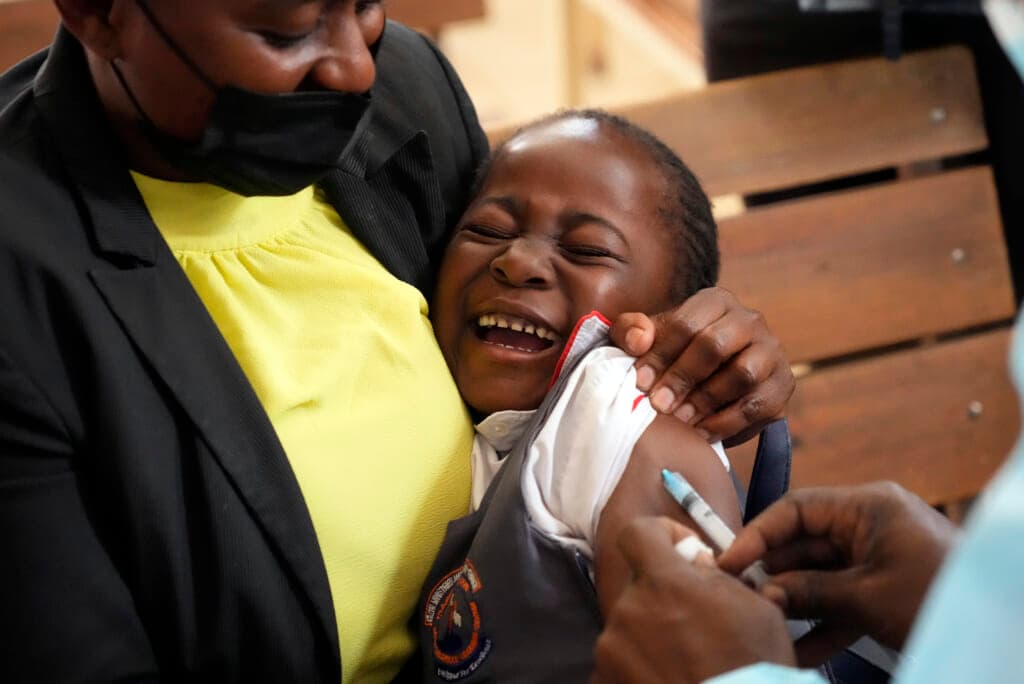 A young girl reacts while been vaccinated against measles at a clinic in Zimbabwe
