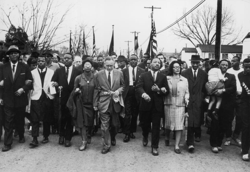 American civil rights campaigner Martin Luther King and his wife Coretta Scott King lead a black voting rights march