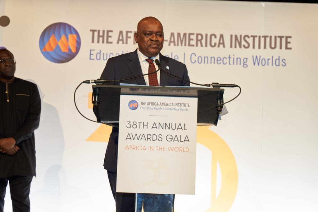 Dr. Mokgweetsi Masisi, president of the Republic of Botswana, stands behind a podium wearing a black suit and red tie
