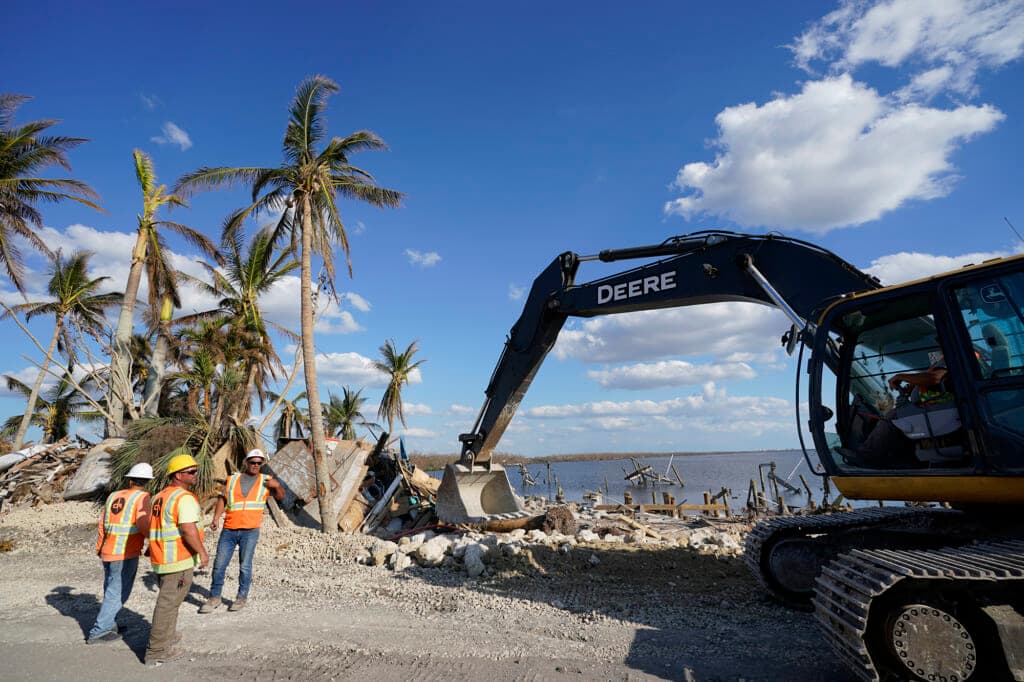 Workers clear debris caused by damage from Hurricane Ian