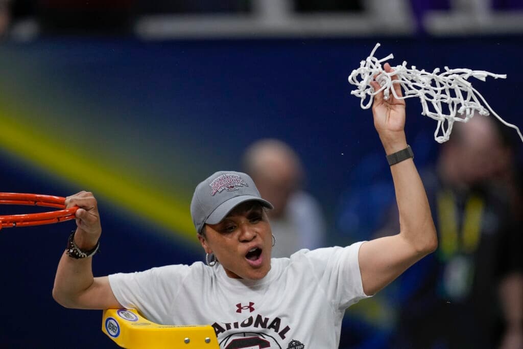 South Carolina head coach Dawn Staley cuts the net after a college basketball game