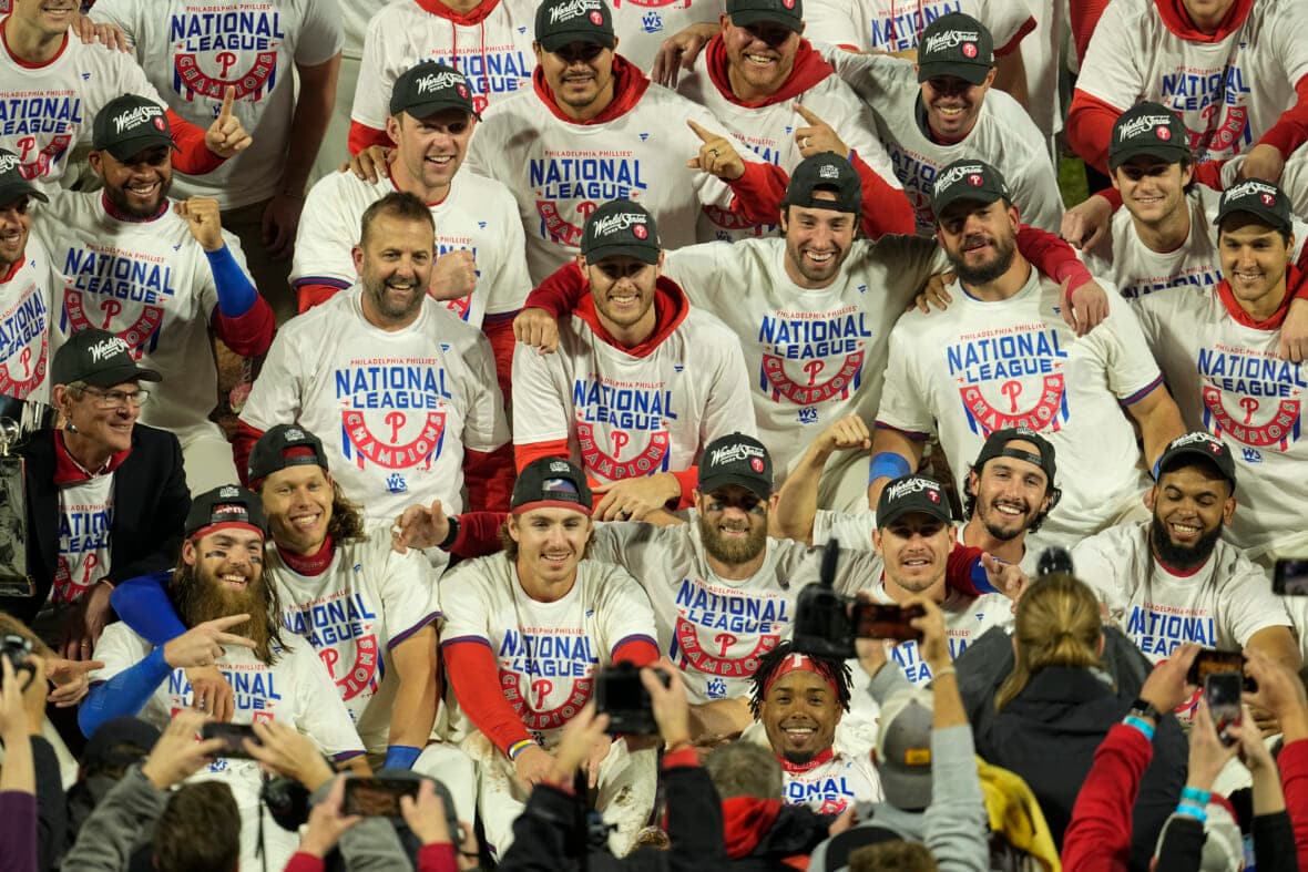 Members of the Philadelphia Phillies baseball team are shown wearing "National League Champions" T-shirts