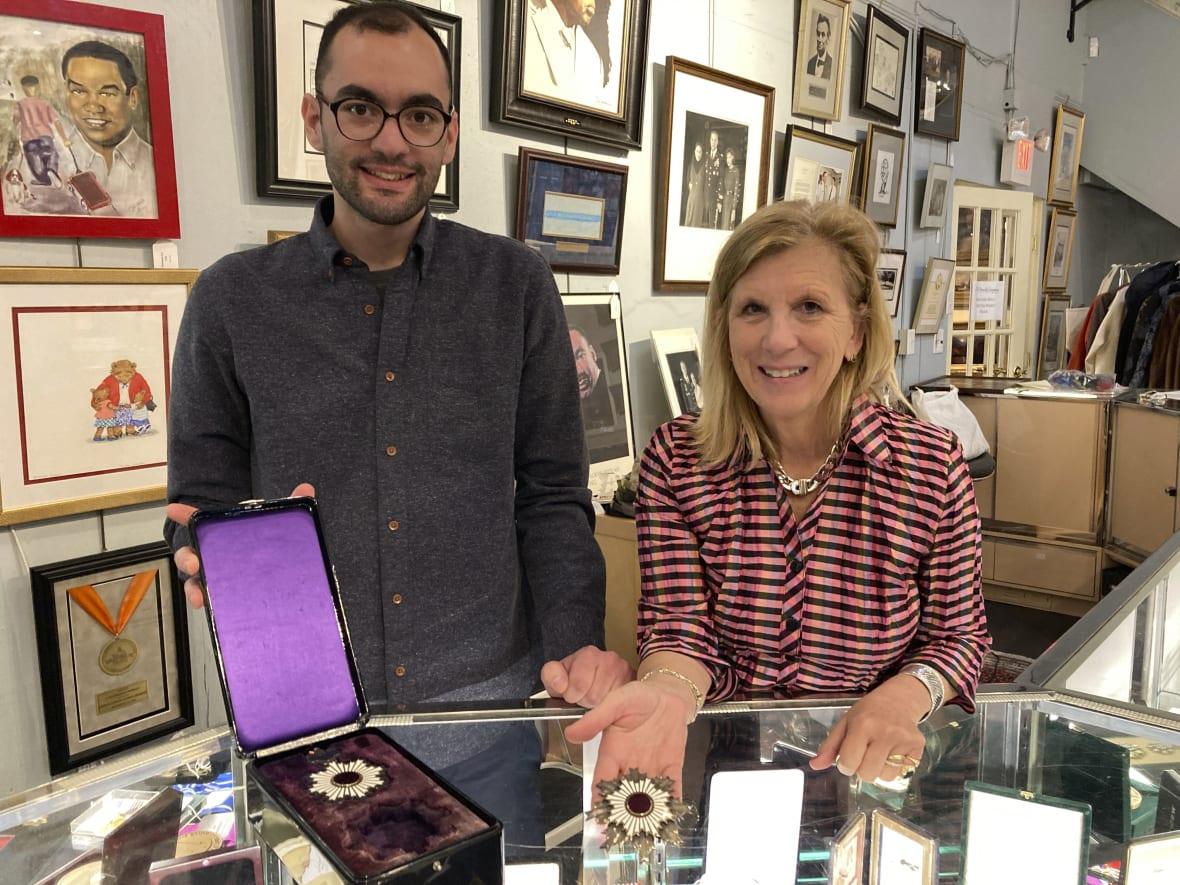 Zachary Diaz and Elizabeth Haynie Wainstein of The Potomack Company display items from the estate of Gen. Colin Powell