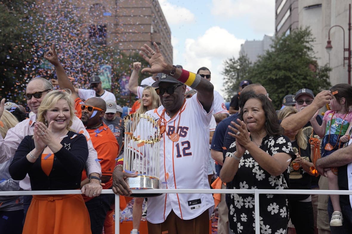 Houston Astros manager Dusty Baker waves during a victory parade
