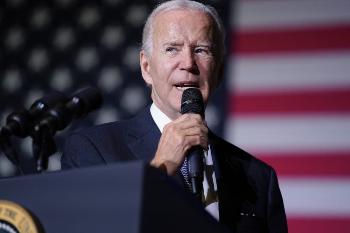 President Joe Biden holding a microphone
