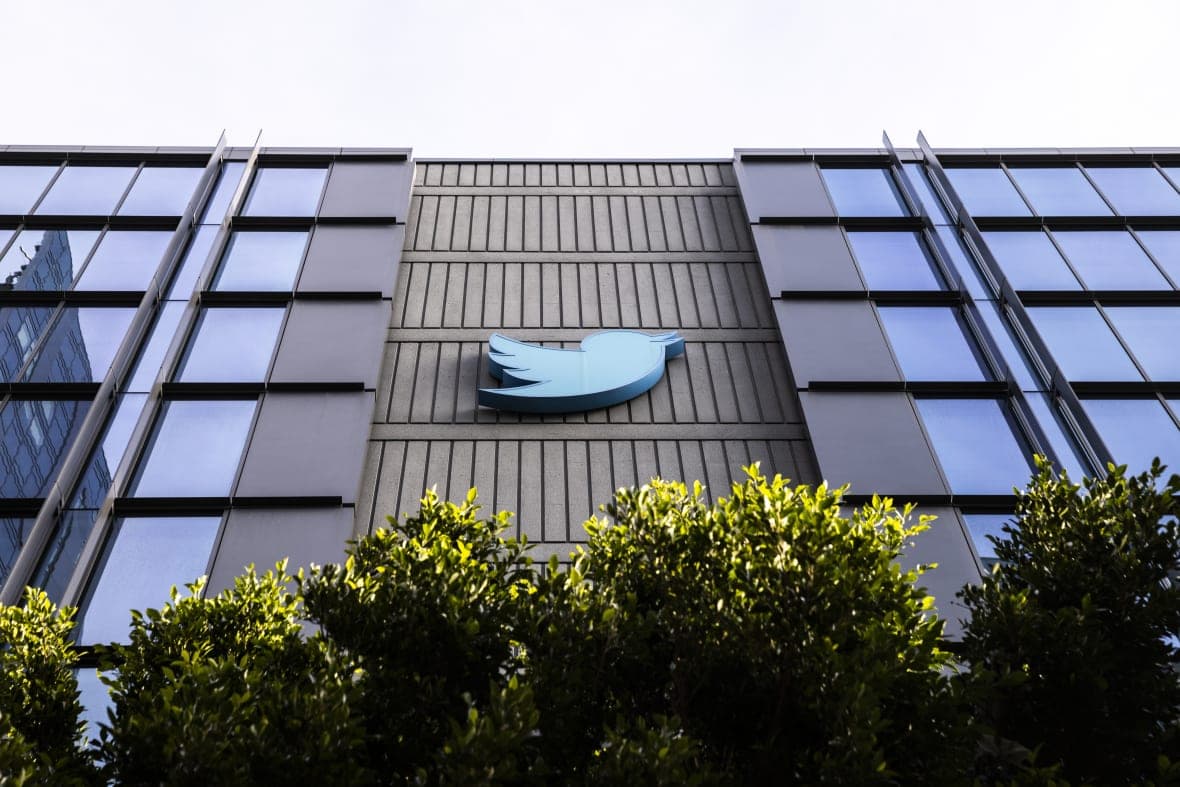 A blue Twitter bird logo is displayed on the side of the company's building in San Francisco