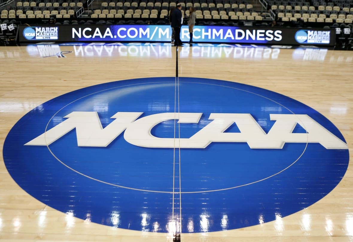 An NCAA logo on a basketball court