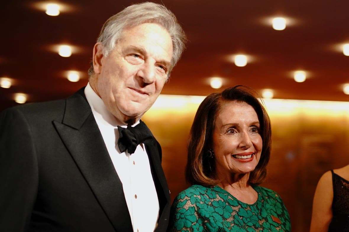 Paul Pelosi, wearing a black tuxedo, and his wife, former House Speaker Nancy Pelosi, wearing a lacy green dress