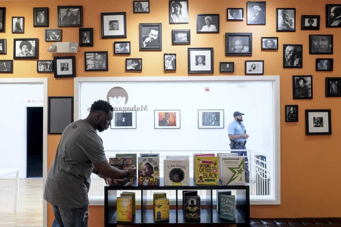 Derrick Young organizes books at Mahogany Books in Washington, DC