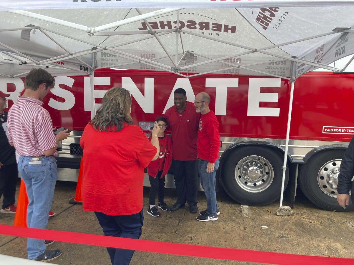 Republican Senate nominee Herschel Walker, a former University of Georgia football star, greets Georgia football fans