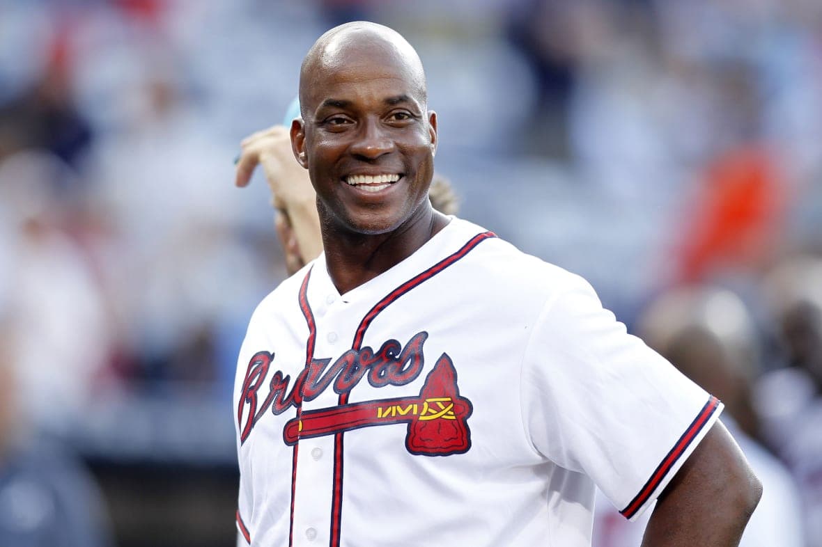 Former Atlanta Braves first baseman Fred McGriff smiles, wearing his Braves uniform