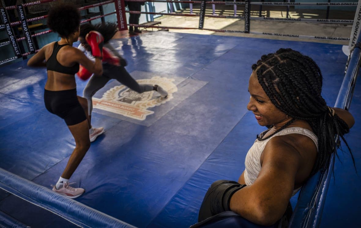 Boxer Ydamelys Moreno, right, watches as fellow female boxers train