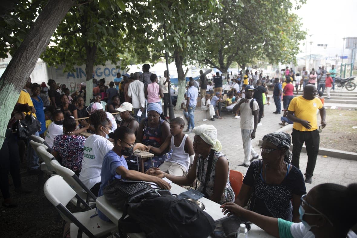 Displaced residents in La Plaine are examined at a mobile medical clinic