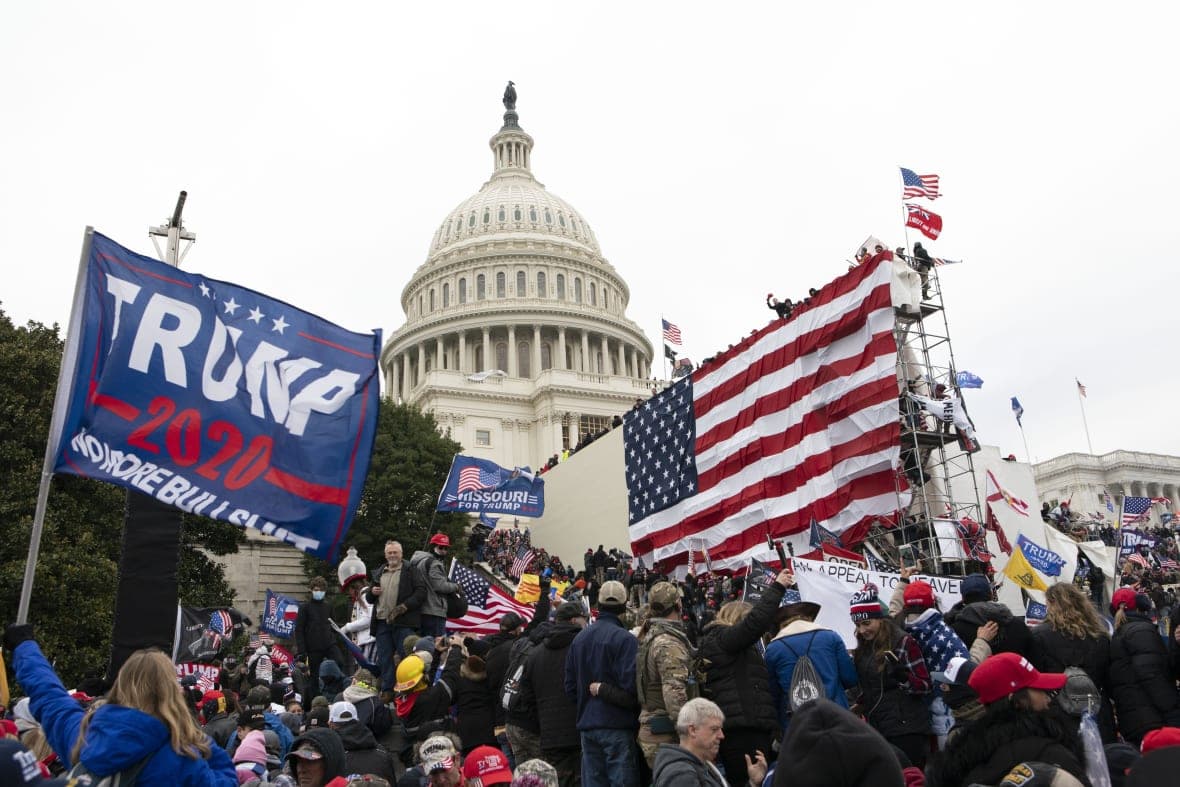 Violent insurrectionists loyal to President Donald Trump stand outside the U.S. Capitol in Washington on January 6, 2021