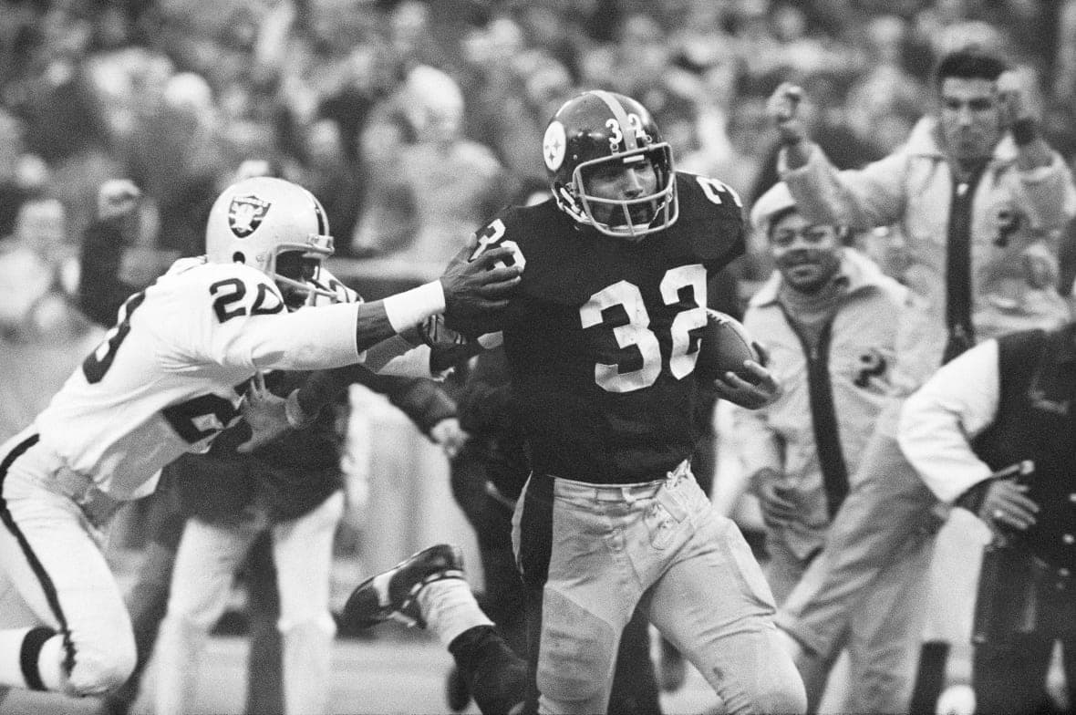 Football player Franco Harris making a play