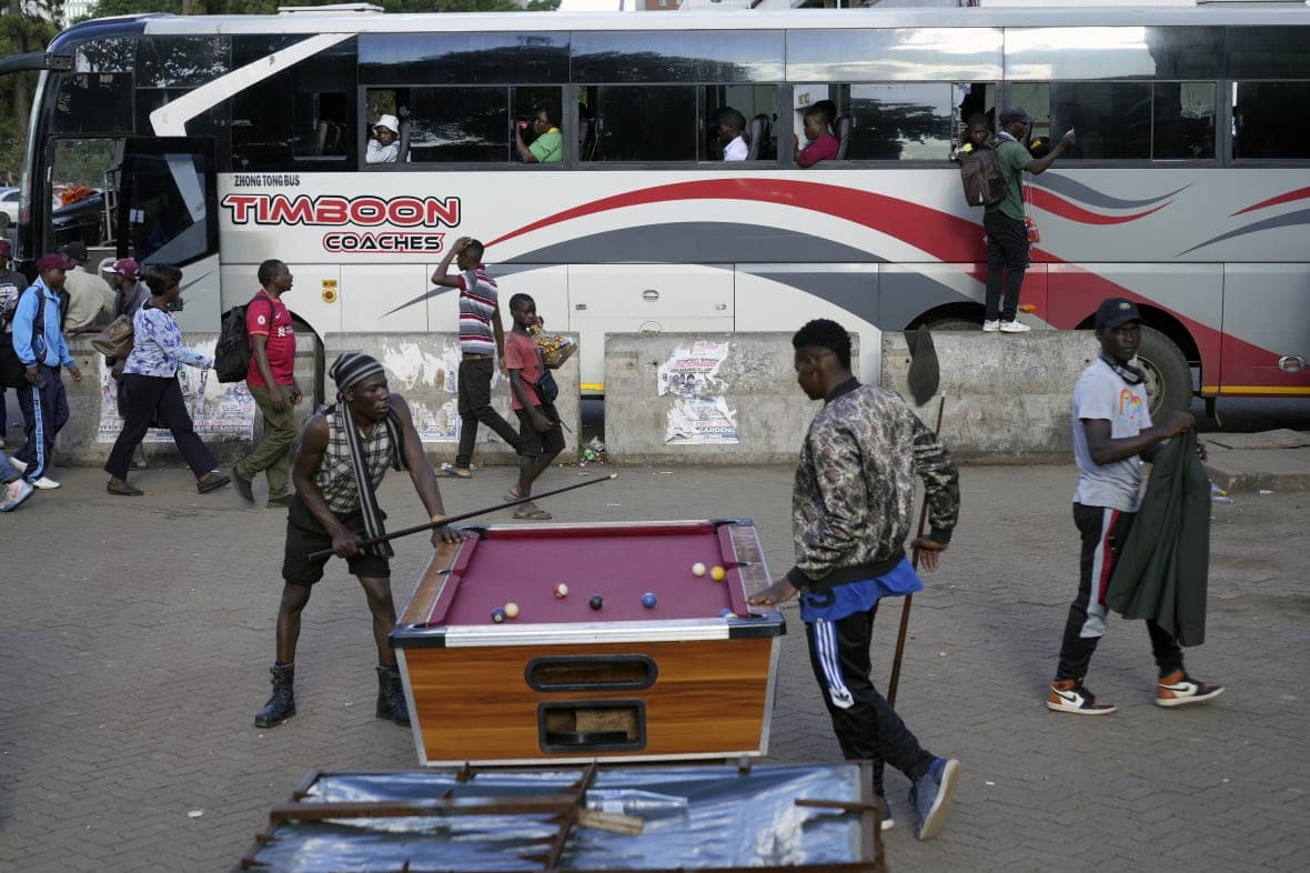 People play pool in an open space in Harare, Zimbabwe