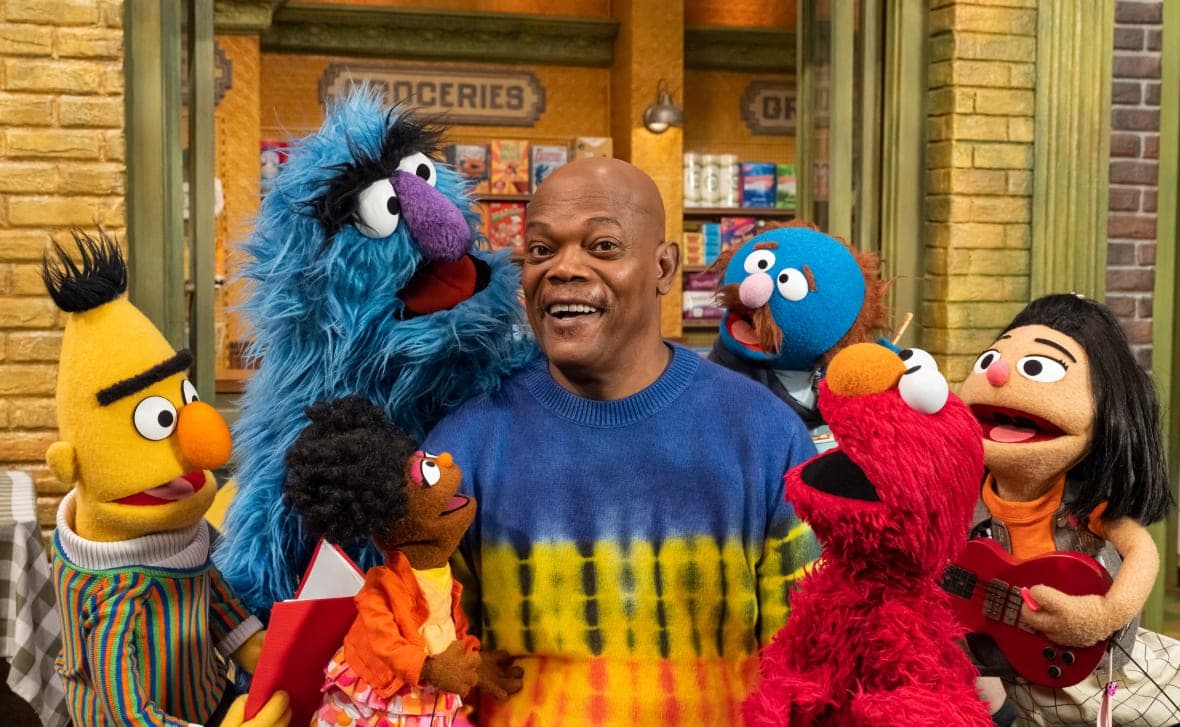 Actor Samuel L. Jackson surrounded by “Sesame Street” characters