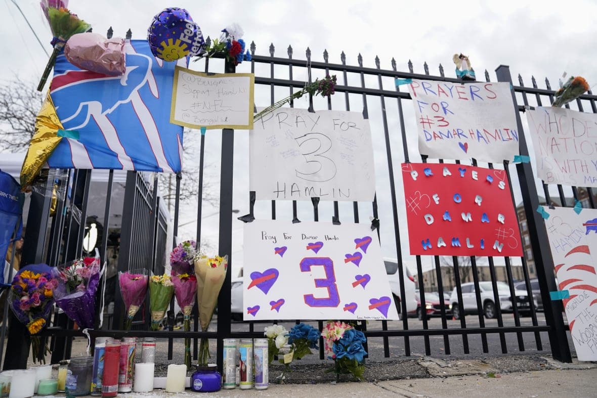 Signs sit along a fence outside UC Medical Center where Buffalo Bills safety Damar Hamiln remains hospitalized