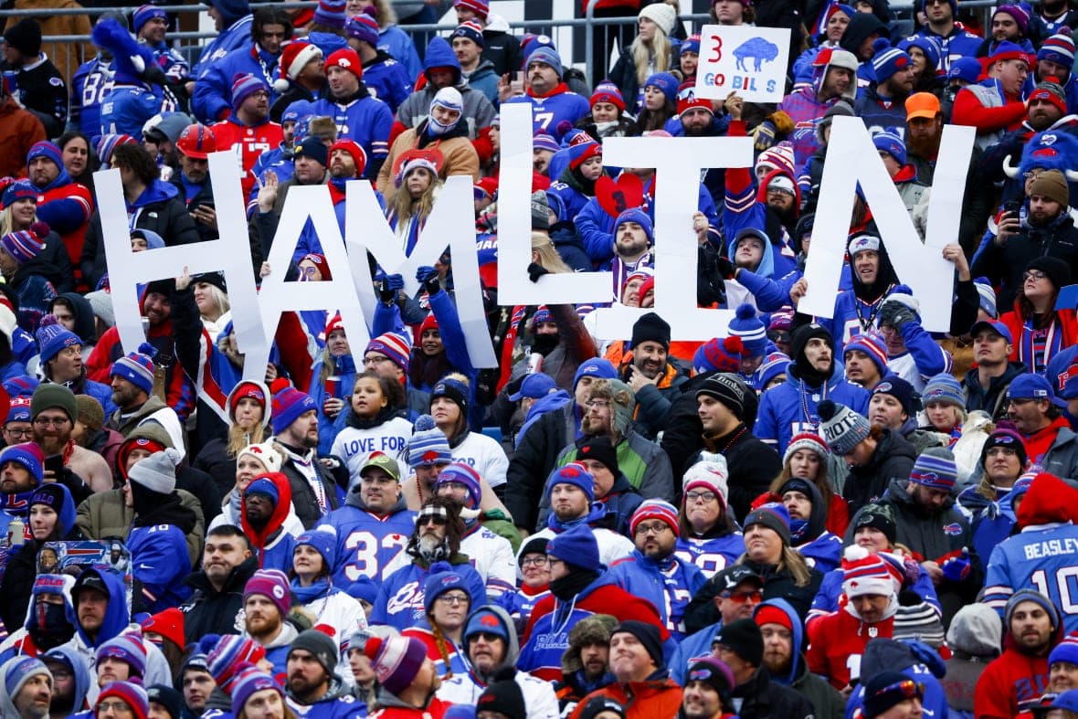 Fans hold a sign in support of Buffalo Bills safety Damar Hamlin