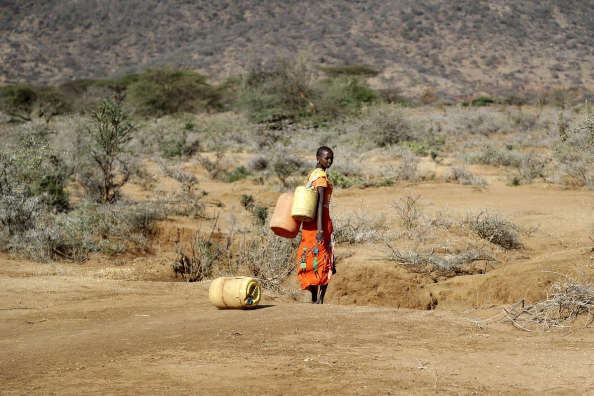 A Samburu woman fetches water during a drought in Kenya