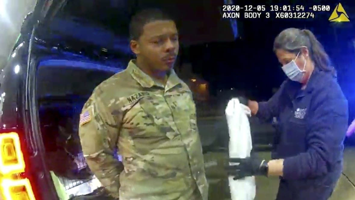 Lt. Caron Nazario being helped by an EMT