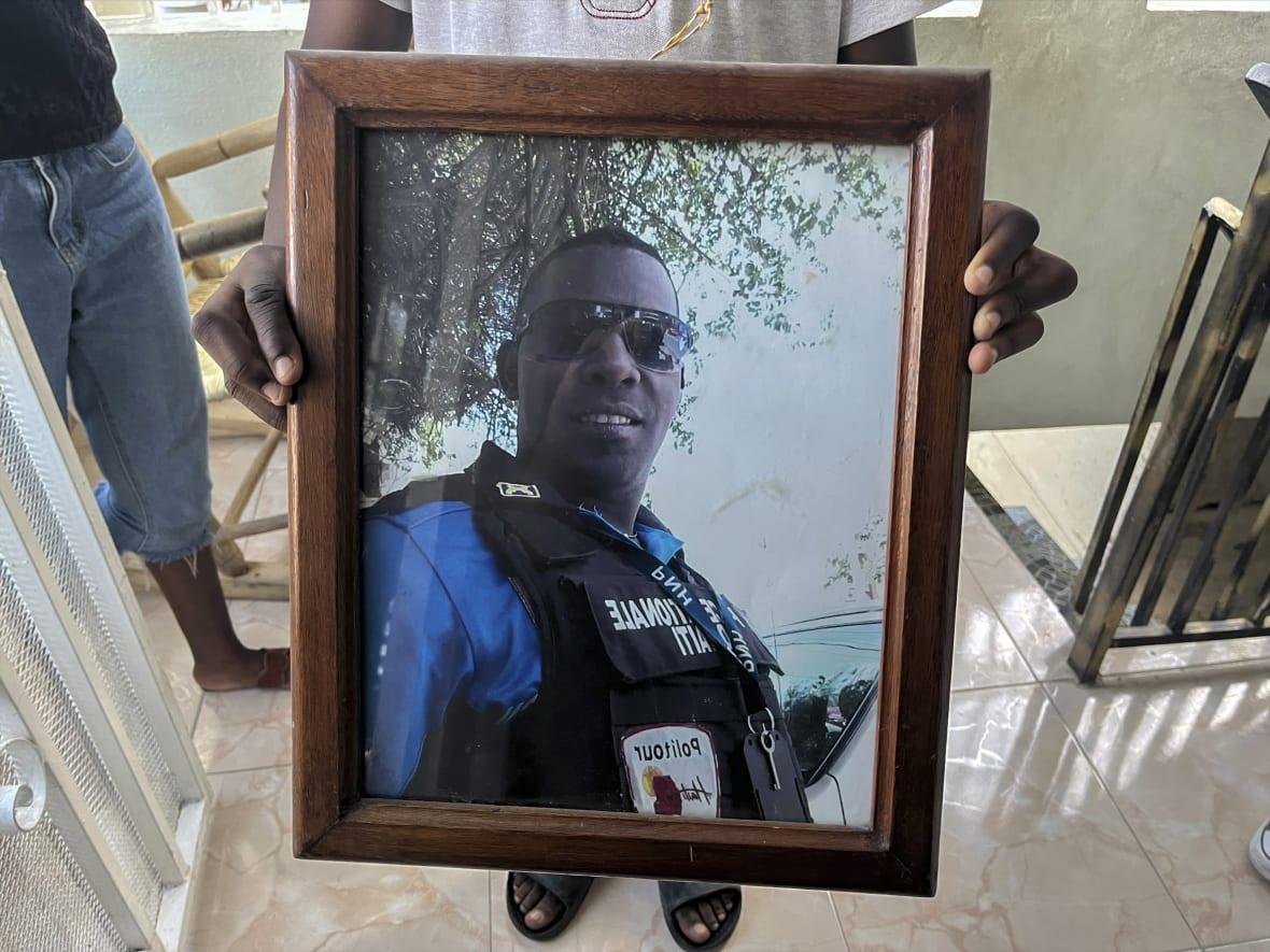 A framed photo of missing Haitian police Officer Ricken Staniclasse