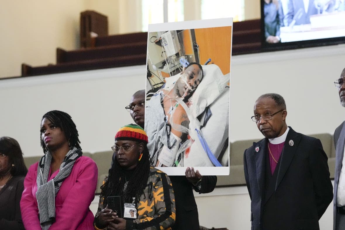 Tyre Nichols' family with a photo of him in the hospital