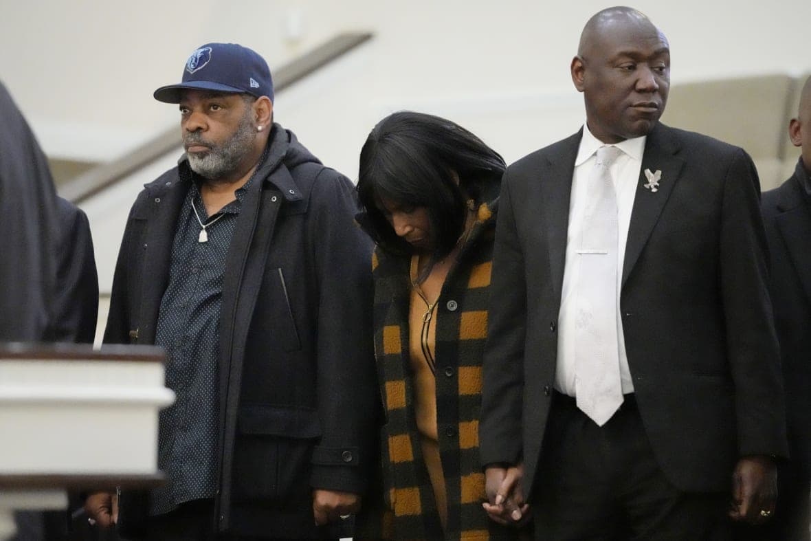 RowVaughn Wells, mother of Tyre Nichols, and Tyre’s stepfather Rodney Wells hold hands with attorney Ben Crump