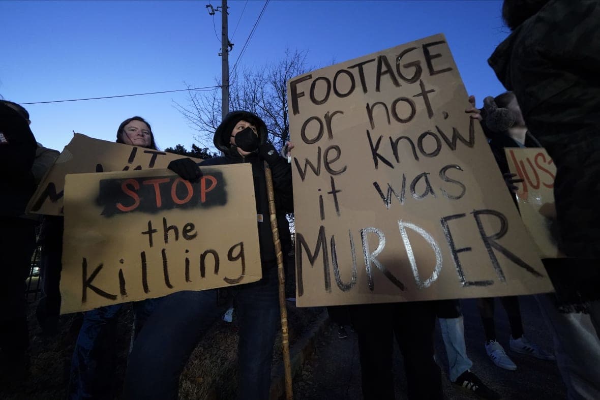 Protesters hold signs decrying Tyre Nichols' death