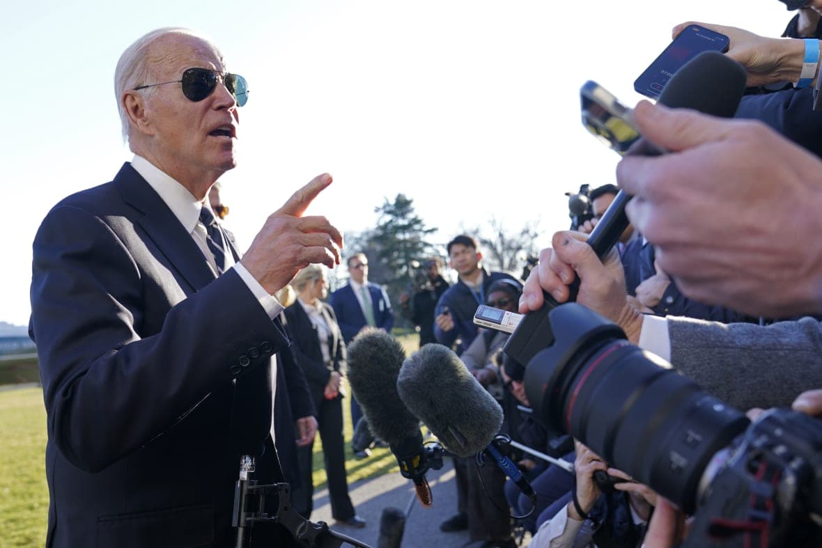 President Joe Biden talks with reporters