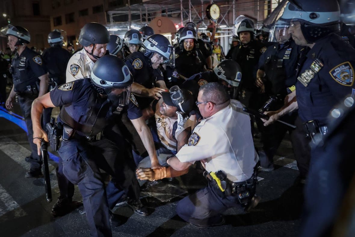 A protester is arrested by NYPD officers during a march