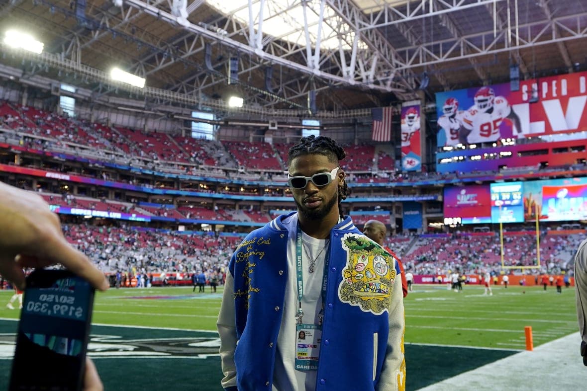 Buffalo Bills player Damar Hamlin wearing a blue jacket and sunglasses