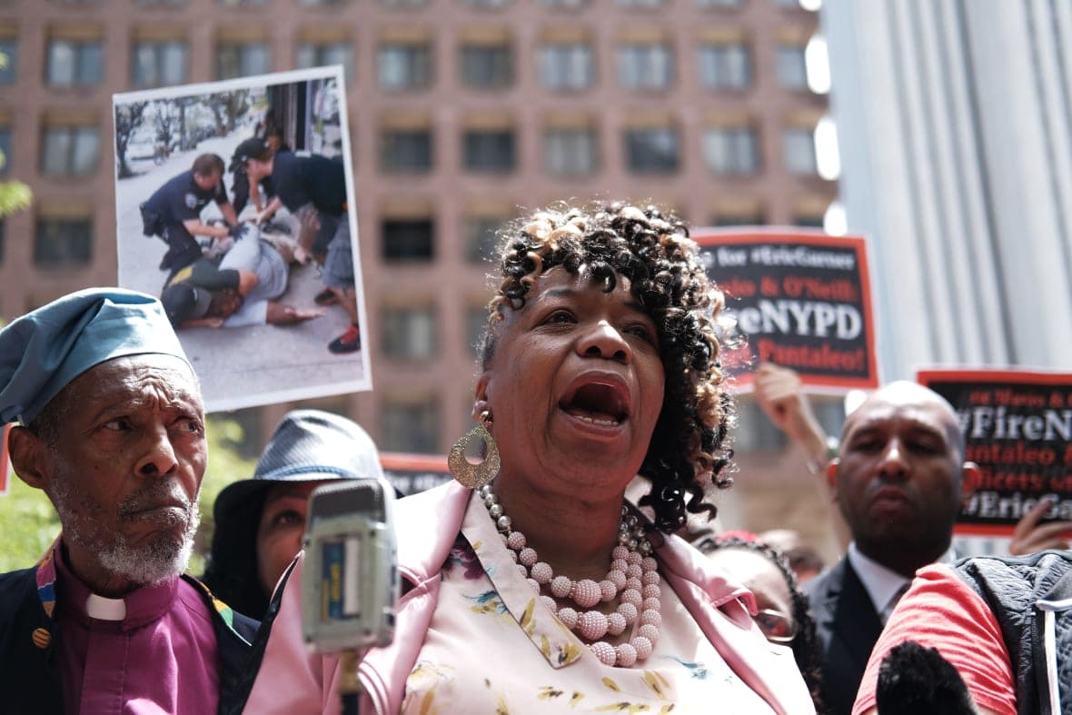 Gwen Carr, mother of Eric Garner, joins others during a news conference