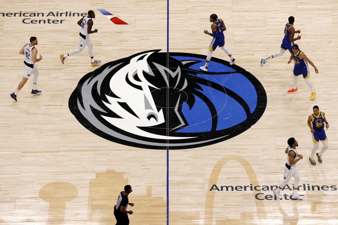 The Dallas Mavericks logo on the court
