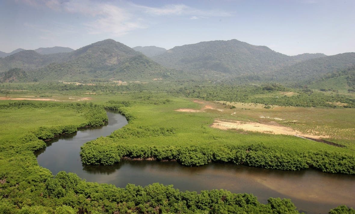 Mountains stand near a river just outside Freetown, Sierra Leone